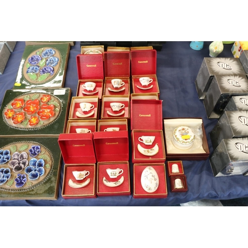 74 - Miniature Caverswall cups and saucers, and Caverswall thimbles, all boxed.