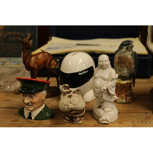 88 - Ornaments to include a money box, a Royal Doulton Peregrine Falcon whisky decanter, etc.