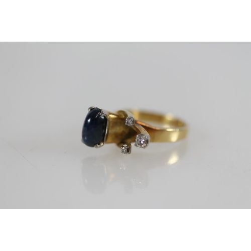 501 - Yellow metal modernist ring set with cabochon sapphire and three small diamonds, size N/O, 9.0g, tes... 