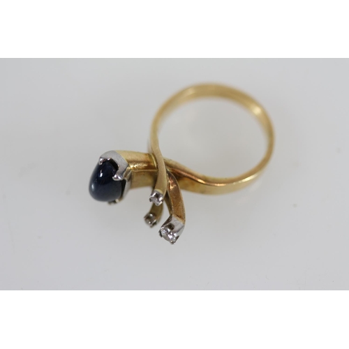 501 - Yellow metal modernist ring set with cabochon sapphire and three small diamonds, size N/O, 9.0g, tes... 