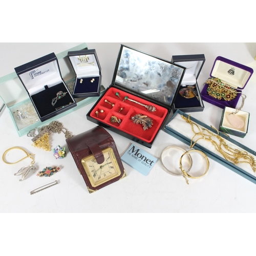 514 - Selection of costume jewellery in red travelling vanity case.