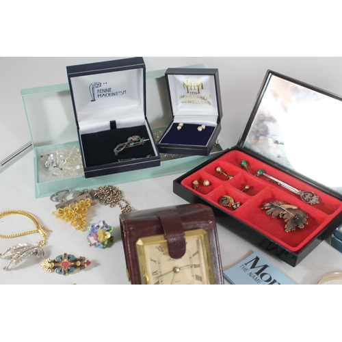 514 - Selection of costume jewellery in red travelling vanity case.