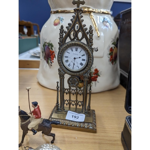 192 - Late Victorian Gothic brass pocket watch holder with a pocket watch, a figure of a knight, die-cast ... 