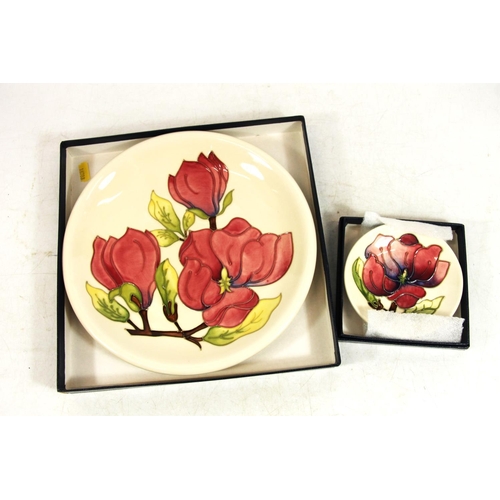 217 - Moorcroft Magnolia plate and matching pin dish, in original boxes.