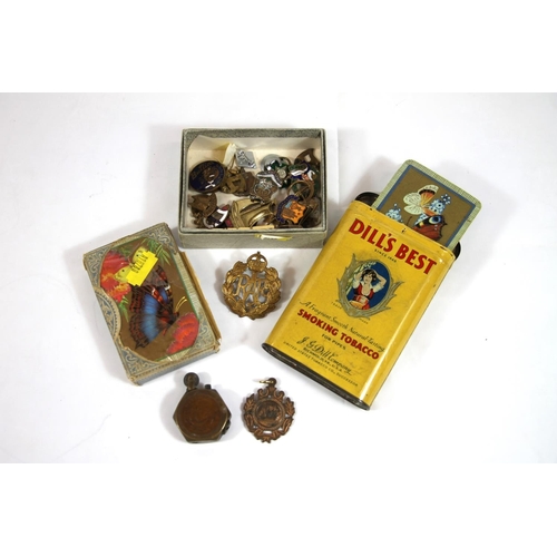 224 - Vintage playing cards, enamel badges, an RAF cap badge and a Trench Art lighter.