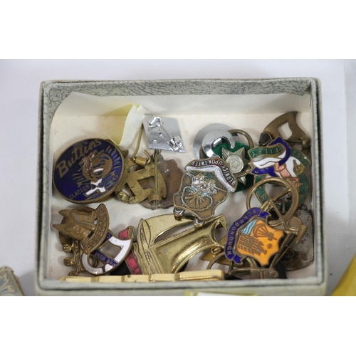 224 - Vintage playing cards, enamel badges, an RAF cap badge and a Trench Art lighter.