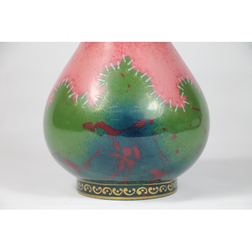 245 - Early 20th century pottery vase with pink and green stitch pattern, sceptre mark to base, 26cm high.