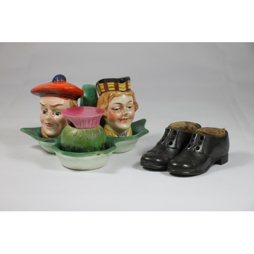 246 - German made pottery cruet set in the form of two Scottish figures with bonnets and a thistle and a p... 