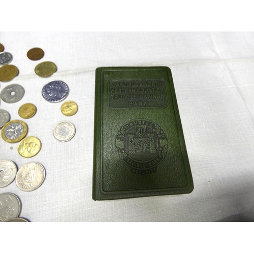 149 - Two vintage savings bank books and world coins.