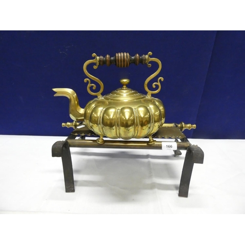 166 - Large brass antique kettle and a fireside trivet.