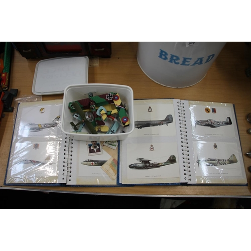 200 - Two folders containing aeroplane related postcards and plastic model aeroplanes.