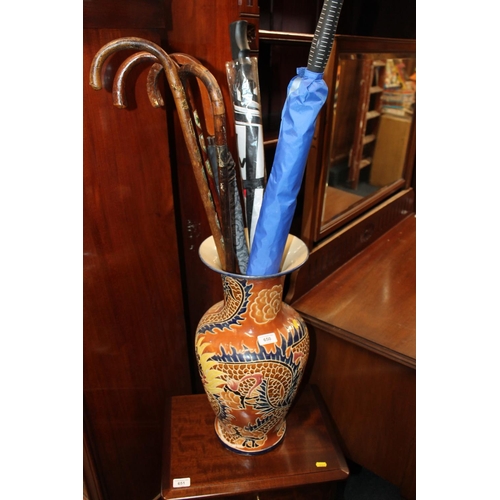 650 - Large ceramic vase together with umbrellas and walking sticks