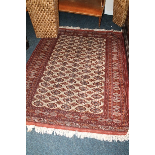 684 - Bokhara rug in rust red and cream with repasting geometric motifs, 196cm x 145cm.