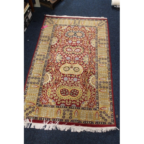 689 - Ferahagn fringed rug with rust red background and mustard design.