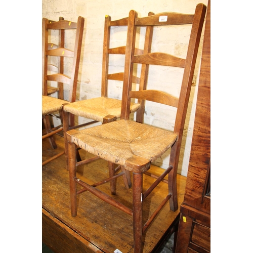 592 - Four ladderback chairs with rush seats.