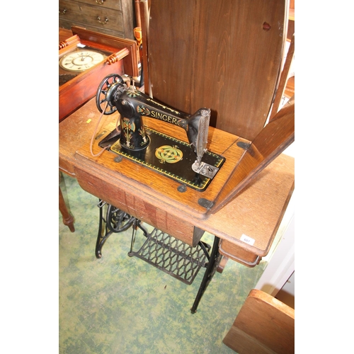 607 - Singer sewing machine in original treadle table.