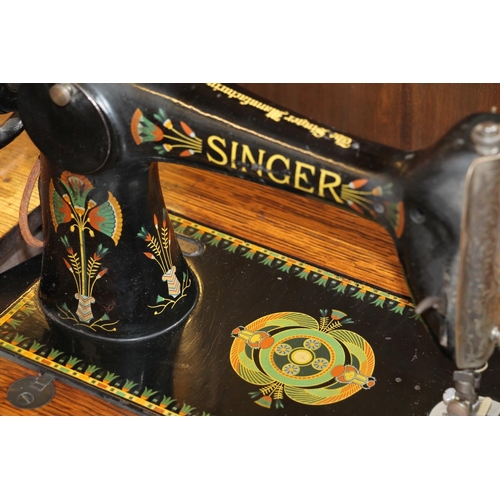 607 - Singer sewing machine in original treadle table.