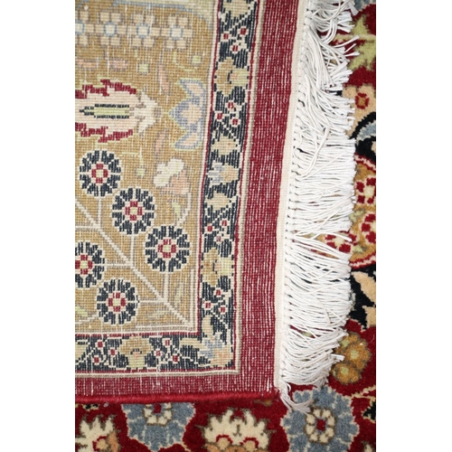 689 - Ferahagn fringed rug with rust red background and mustard design.