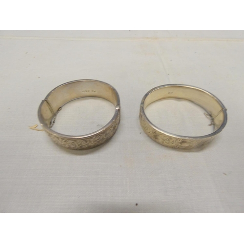 249 - Two large silver bangles.