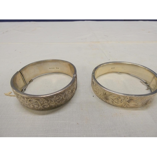 249 - Two large silver bangles.