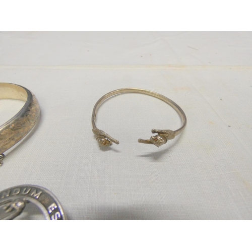 250 - Hinged silver bangle, silver panther bracelet and a clan badge (3)