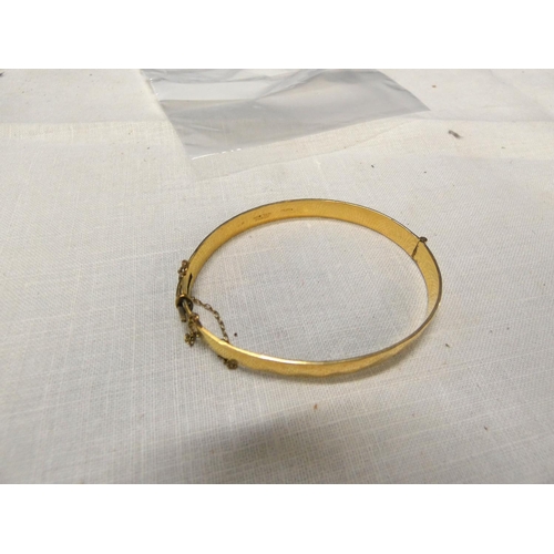 254 - Hinged rolled gold bangle.