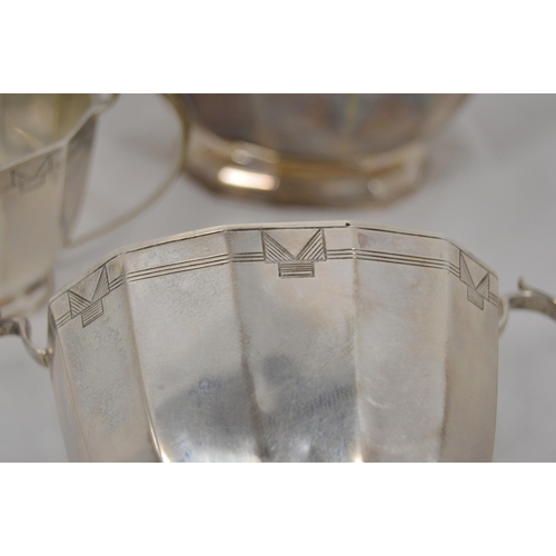 40 - Silver three-piece tea set of Art Deco style with cut corners and typical engraving, by Viner, Sheff... 