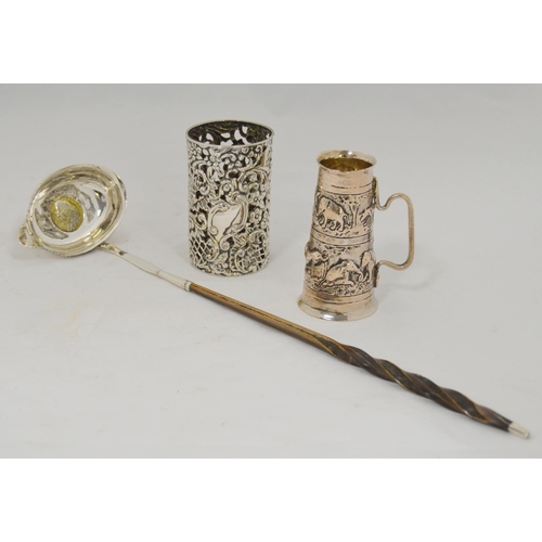 47 - Indian silver embossed double measure, silver bottle holder, and a silver toddy ladle with inset shi... 