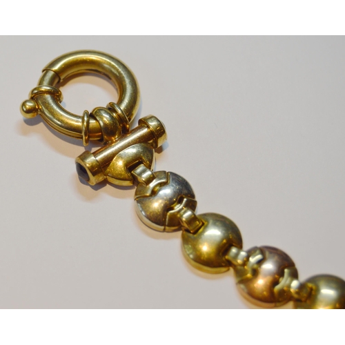 138 - 9ct coloured gold bracelet with hinged button links, 17.4g.