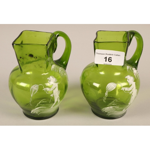 16 - Two green glass Mary Gregory jugs, each jug 13cm high