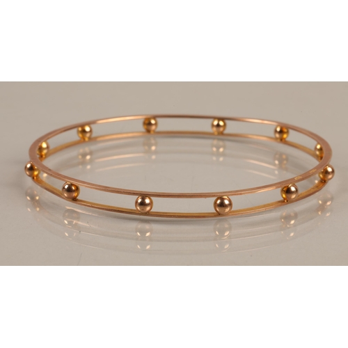 55 - 9ct gold stiff bangle, 10.9g