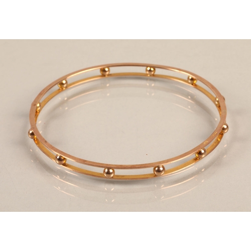 55 - 9ct gold stiff bangle, 10.9g