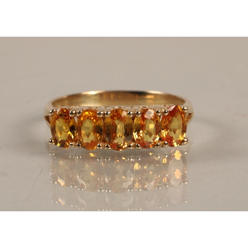 63 - 9K gold band set with five bright citrus coloured gems, ring size U, gross weight 3.8g