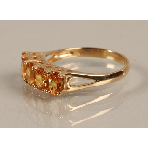 63 - 9K gold band set with five bright citrus coloured gems, ring size U, gross weight 3.8g