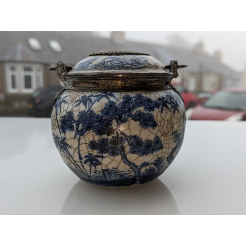 234 - Oriental blue and white pottery pot with metal handle and metal mounts in the form of hanging bats, ... 