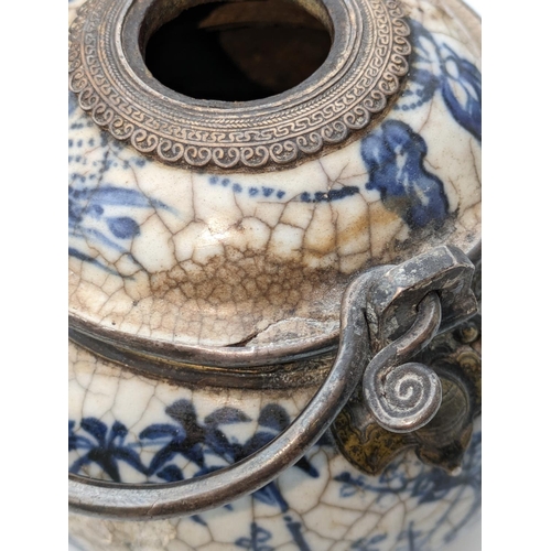 234 - Oriental blue and white pottery pot with metal handle and metal mounts in the form of hanging bats, ... 