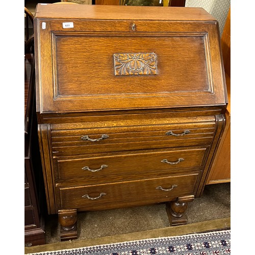 651 - Oak three-drawer writing bureau with floral design in relief, 104cm high