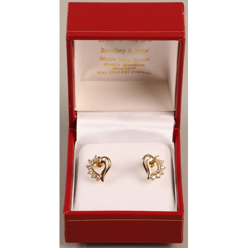 136 - Pair of yellow metal stud earrings set with diamonds