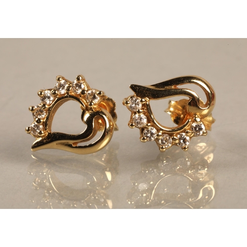 136 - Pair of yellow metal stud earrings set with diamonds