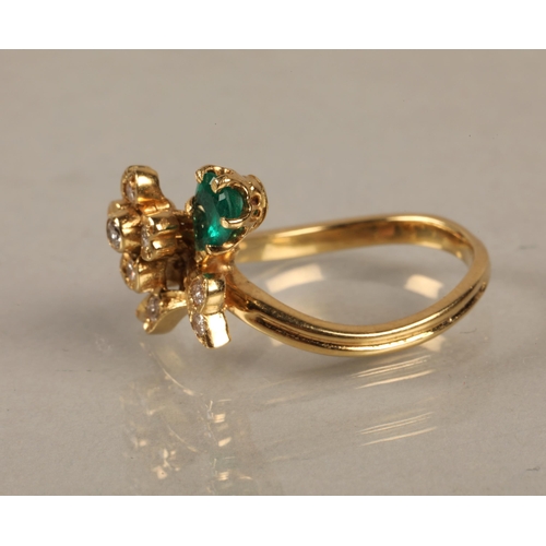 138 - Yellow metal ring set with a green gem and diamonds in a flower design, gross weight 4.5g, ring size... 