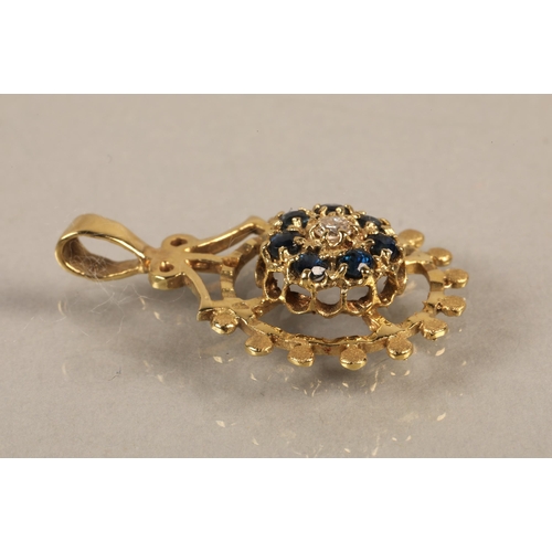 140 - 14K gold pendant set with a central diamond surrounded by blue gems, gross weight 2.5g