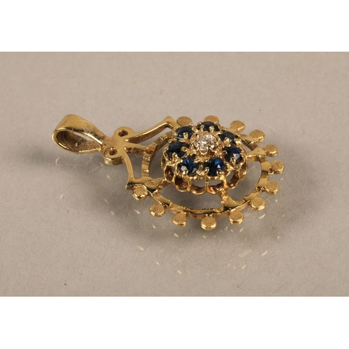 140 - 14K gold pendant set with a central diamond surrounded by blue gems, gross weight 2.5g