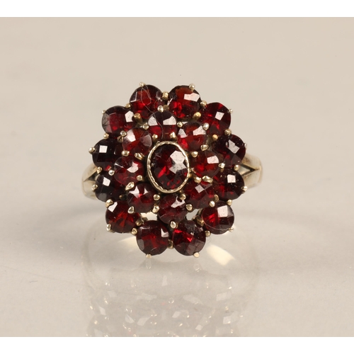 99 - Silver ring set with a cluster of garnets, ring size J