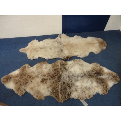 106 - Two simulated animal skin rugs.  (2)