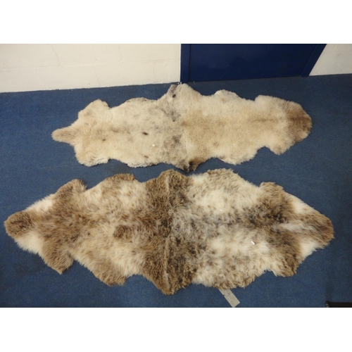 106 - Two simulated animal skin rugs.  (2)