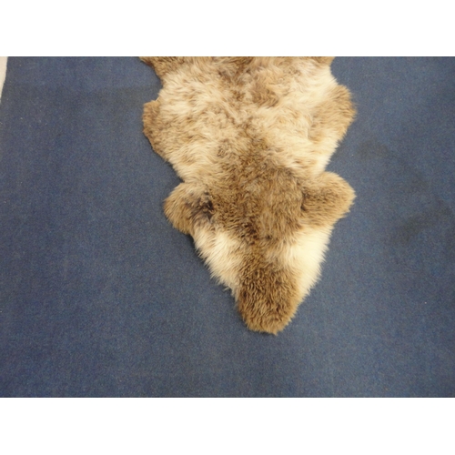 106 - Two simulated animal skin rugs.  (2)