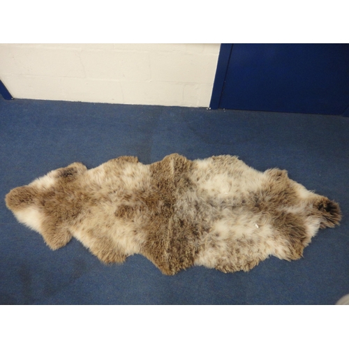 106 - Two simulated animal skin rugs.  (2)