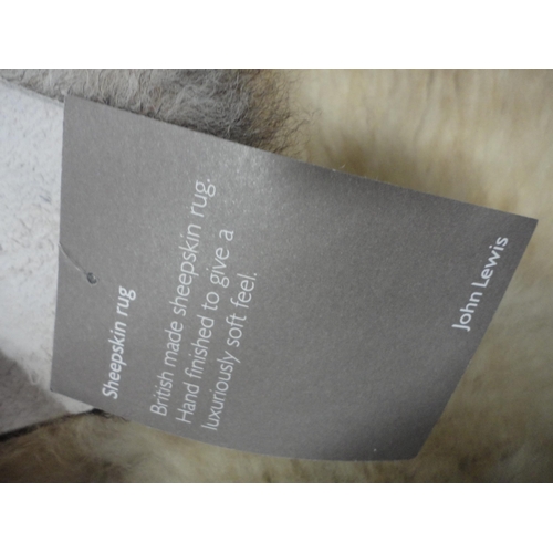 114 - Two John Lewis sheepskin rugs.  (2)