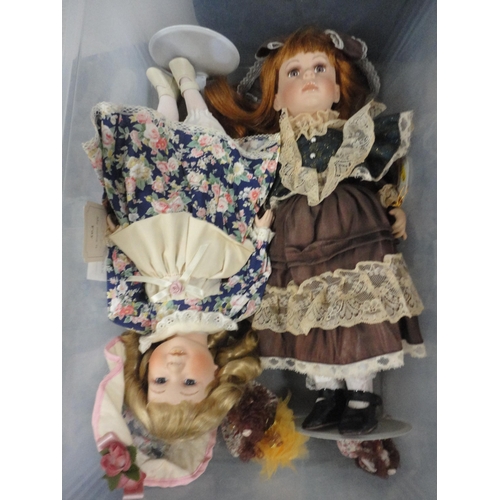 187 - Two cartons containing modern china-headed dolls, carton containing annuals and books to include The... 