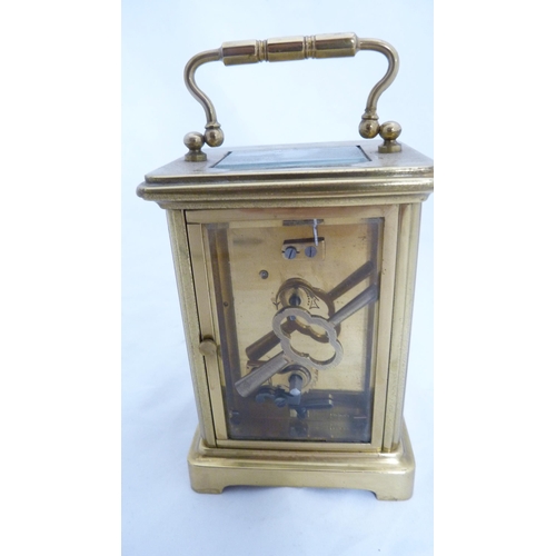 233 - Brass four glass carriage clock, with key.